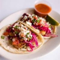 Seafood Tacos (4) · Tacos dressed with seasoned red cabbage, pico de gallo, queso fresco, and our delicious home...