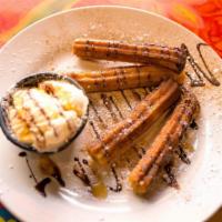 Churros · Homemade churros with a cream filling. Served warm with vanilla ice-cream