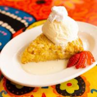 Pan de Elote · Our homemade Mexican Sweet corn cake is served warm alongside vanilla ice cream and drizzled...