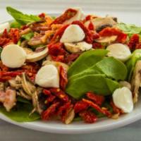 Spinach Salad · Fresh spinach, roasted garlic, artichoke hearts, bacon, mushrooms, black olives, and feta ch...