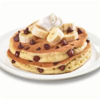 Stack of Choconana Pancakes  · Ghirardelli® chocolate chips cooked inside buttermilk pancakes. Topped with bananas, more Gh...