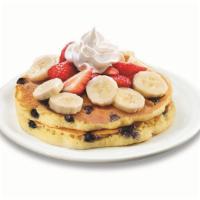 Stack of Double Berry Banana Strawberry Pancakes  · Buttermilk pancakes cooked with blueberries and topped with fresh seasonal berries, bananas ...