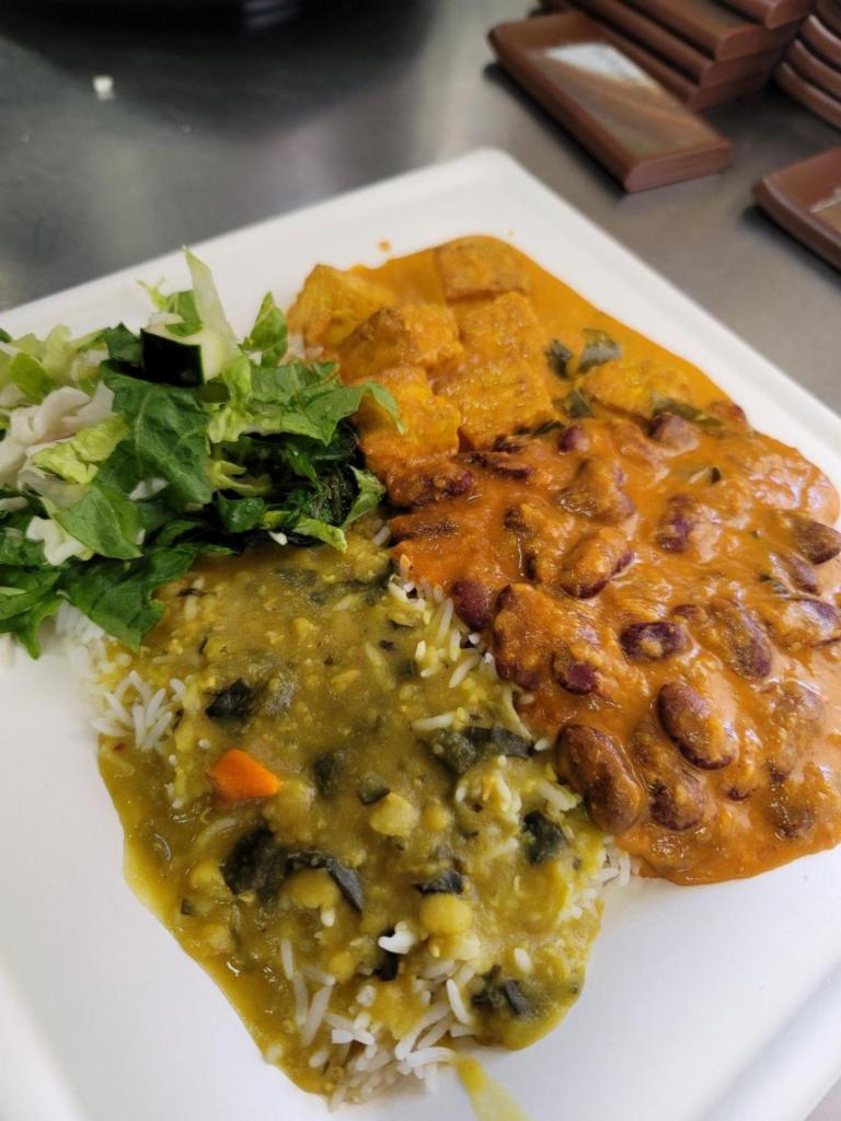 Vegan Entrée Plate · Each plate comes with rice, lentils, a small side of salad, and a roti. Our Photo is an example of Kidney bean Rajma and Tofu. (Our options change daily and weekly)