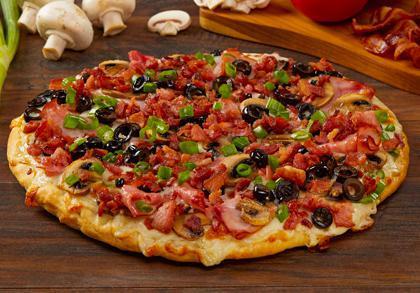 Sizzlin' Bacon Classic · A family favorite! Crispy bacon, tender ham, sliced mushrooms, olives and green onions on creamy garlic sauce. - (150-380 cal./slice)