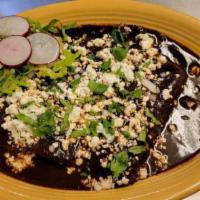 Emoladas · Mole enchiladas. 3 chicken enchiladas covered in a delicious black Oaxacan mole served with ...