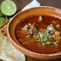 Birria de Chivo · Slow-braised goat cooked in a delicious broth with Mexican chiles, herbs, and spices.