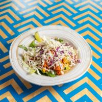 Spicy Pollo Burrito · Pulled chicken, arbol sauce, citrus slaw, black beans, rice, lettuce, crema, and salsa roja. 