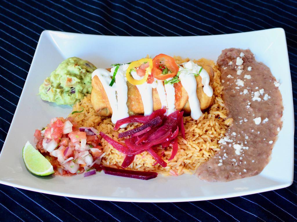 Pulled Chicken Chimichanga · Rice, refried beans, pico de gallo, guacamole and sour cream.