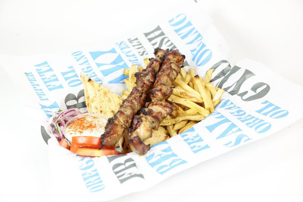 Pork Souvlaki Plate · Fresh cut pork, skewered and seasoned with Greek spices, cooked over an open flame, served with French fries, greek salad, tzatziki sauce and pita bread.