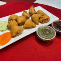Cocktail Samosa (10 Pcs) · Crispy pastry stuffed with potatoes, green peas, and deep-fried. Served 10 PCS