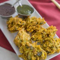 Vegetable Pakora · Savory vegetable fritters, mildly spiced, dipped in batter, and deep-fried.