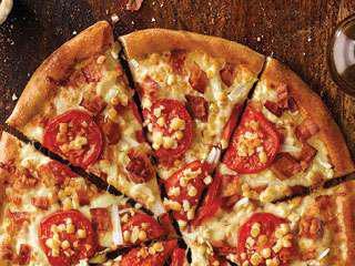 White Cheezy Pizza · Bacon, onions, sliced tomatoes, garlic parmesan sauce and our three-cheese blend, plus feta.