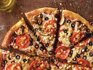 Garden Pizza · Mushrooms, black olives, onions, sliced tomatoes, our signature sauce and three-cheese blend, plus feta.