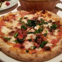 Prosciutto San Daniele Pizza · Fresh mozzarella, fresh tomato, arugula and prosciutto San Daniele.
