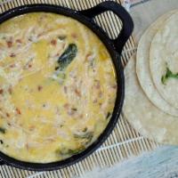 Queso Fundido con Rajas de Chile Poblano · Hot melted Mexican cheeses with roasted poblano peppers. Comes with flour tortillas