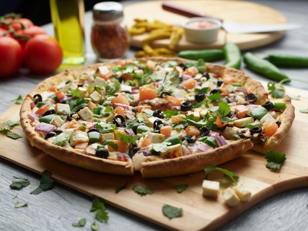 Curry Veggie Pizza Twist · This pizza has our signature curry sauce, fresh diced mozzarella cheese, fresh mushrooms, crisp red onions, sliced black olives, juicy tomatoes, fresh cut; garlic, ginger and green chilies, garnished with fresh cilantro.