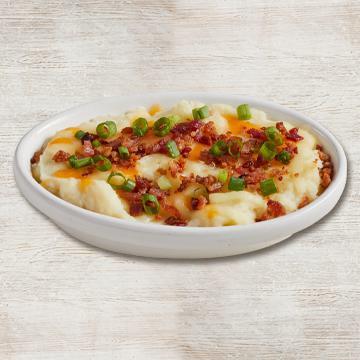 Loaded Mashed Potatoes · Creamy mashed potatoes blended with cheddar cheese, sour cream and real butter. Topped with more cheese and bacon.
