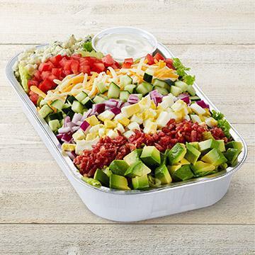 Million Dollar Cobb Party Tray · Mixed greens, carrots, red cabbage, avocado, tomatoes, chopped cage-free egg, bacon, blue cheese, red onions, cucumber, Jack cheese, cheddar & Ranch dressing on the side.
