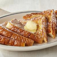 Our Original French Toast · Six triangles of thick-cut French toast topped with whipped real butter & dusted with powder...