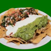 Vegetarian Nachos · Corn chips topped with refried beans and cheese, topped with sour cream, guacamole and pico ...