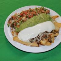 Nacho Fries · French fries topped with re-fried beans, cheese, choice of meat, sour cream, guacamole and p...