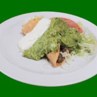 Crispy Taco · Crispy flour tortilla with beans, lettuce, salsa, sour cream, guacamole and cheese.