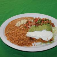 Flautas Dinner Plate · 4 fried rolled corn tortillas with chicken, re-fried beans, rice, topped with guacamole, sou...