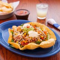 Taco Salad · This is big! Crisp tortilla bowl filled with shredded lettuce, cheese, corn salsa, salsa fre...