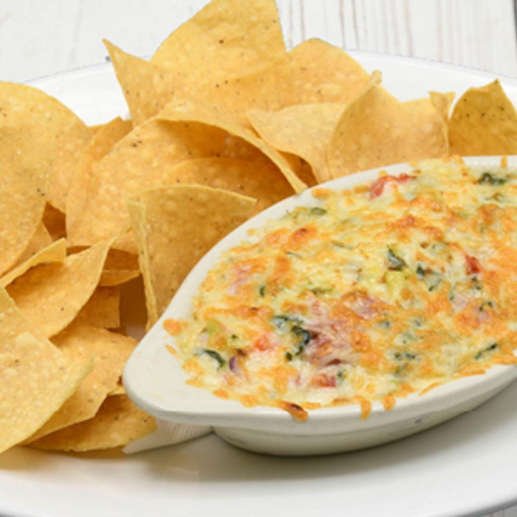 Spinach & Artichoke Dip · Spinach, artichokes, roasted red bell pepers, red onions, Monterey jack & Parmesan cheeses, house made tortilla chips.