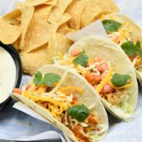 Blackened Shrimp Tacos · Blackened shrimp,  with green cabbage, cilantro, tomatoes, shredded cheese, and avocado lime...