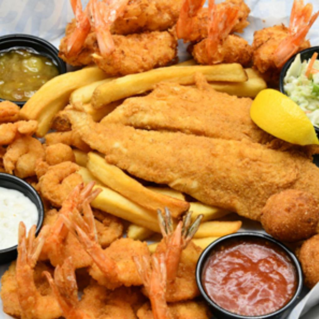 Shrimp & Seafood Ensemble · Crispy fried shrimp, coconut shrimp, popcorn shrimp, fish fillet, with fries, coleslaw and hushpuppies.