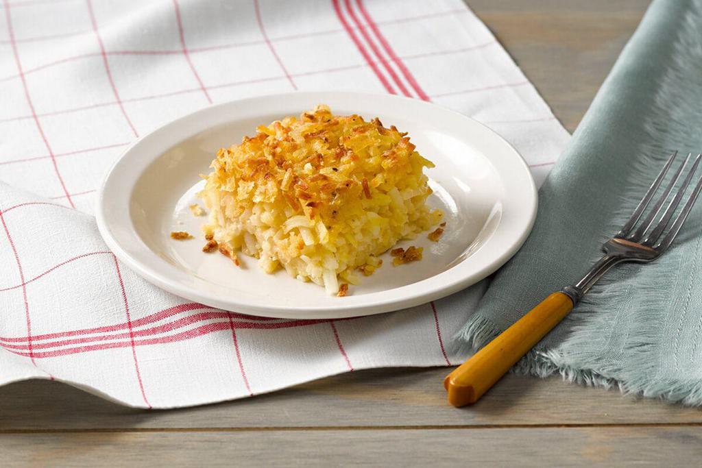 Hashbrown Casserole · Shredded potatoes, Colby cheese, chopped onions, our signature seasoning blend, salt and pepper baked together in the oven for our Signature Hashbrown Casserole.

