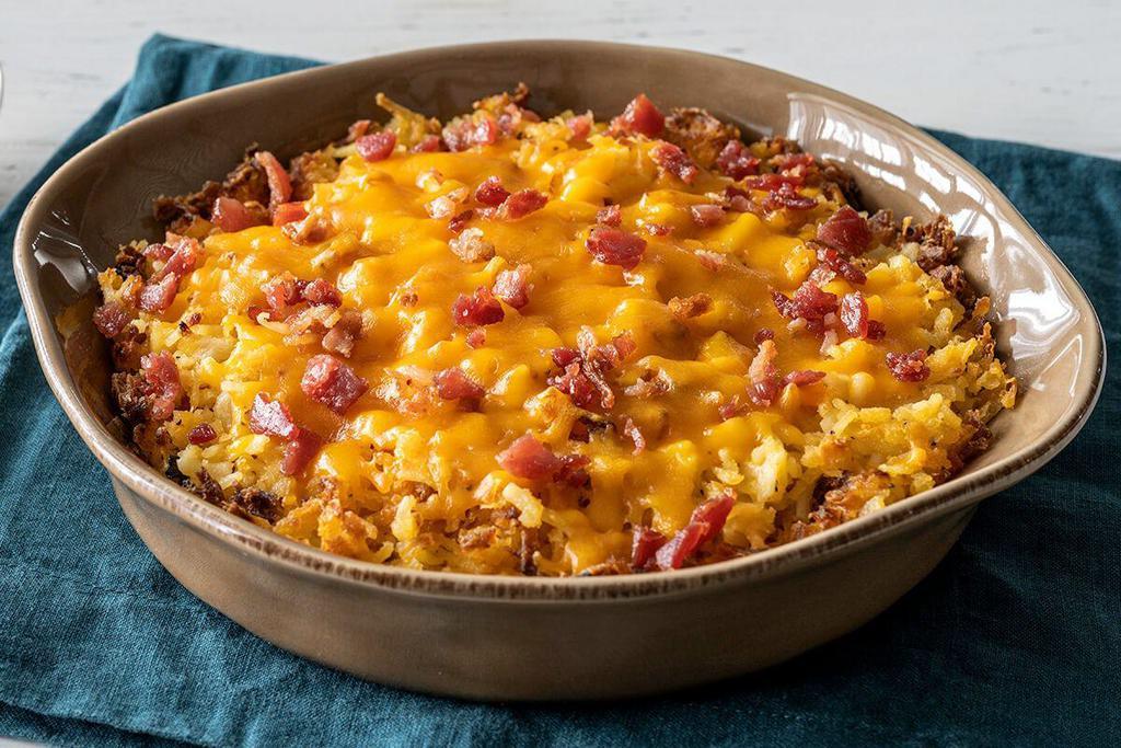 Loaded Hashbrown Casserole · Our Hashbrown Casserole grilled and topped with Colby Cheese, and bacon pieces. Packed hot and ready to serve.


