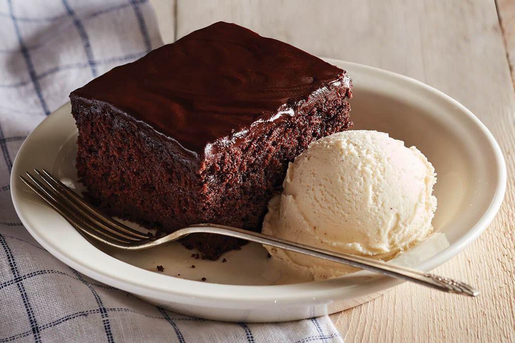 Double Chocolate Fudge Coca-Cola® Cake · Rich, warm double chocolate fudge cake made with real Coca-Cola®. We make it daily, by hand, and serve it warm with rich, creamy vanilla ice cream. A true Cracker Barrel Old Country Store® tradition.

