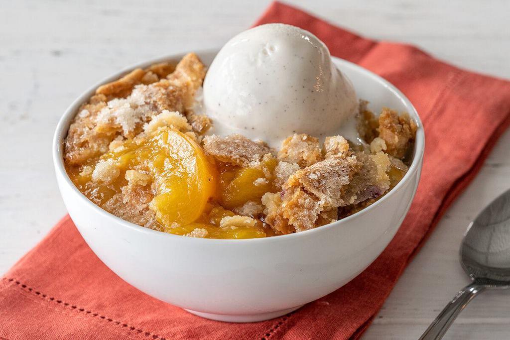 Fruit Cobbler · Made with seasonal fruit and served with Rich, Creamy Vanilla Ice Cream.

