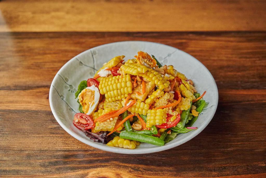 Tum Khao Pod Kai Kem Salad 🌶 · Spiced corn salad with salted egg, peanut, string bean, tomato and carrot.