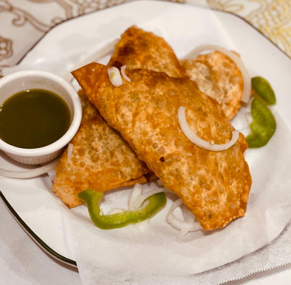 Samosa · 3 pieces of fried pastry filled with potaoes, onions, & peas