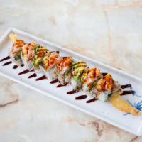 Tiger Roll · Inside: shrimp tempura, cucumber, avocado and crabmeat. Outside: cooked shrimp and eel sauce.
