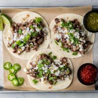 Grilled Steak Street Tacos · 3 tacos. Queso fresca, charred onions, salsa verde and fresh cilantro.