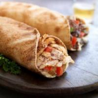 Chicken Shawarma Wrap · our world famous, slow cooked chicken stacked on a vertical spit, carved & dressed with pota...
