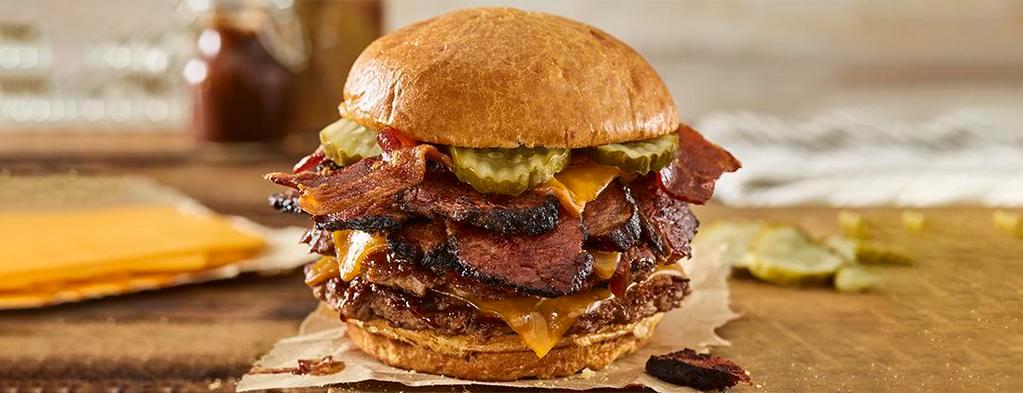 Double Smoked Bacon Brisket Burger · Double Certified Angus Beef, smoked aged cheddar cheese, brisket, applewood smoked bacon, pickles, bbq sauce, toasted brioche bun.