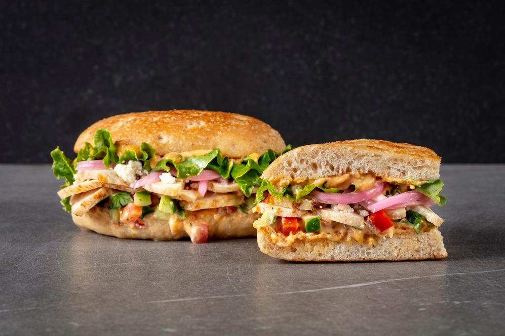 Mediterranean Chicken Sandwich Special · roasted chicken, garlic red pepper hummus, green leaf lettuce, tomato cucumber salsa, pickled red onions, feta cheese.  Served with Urbane Side Salad