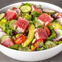 The Ahi Salad · Sashimi grade ahi tuna, Asian greens, avocado, feta cheese, edamame, cucumbers, red radish, ...