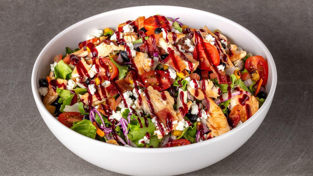 Santa Maria BBQ Chicken Salad · Roasted BBQ chicken, chop salad slaw mix, Apple wood smoked bacon, crumbled goat cheese, corn and black bean salsa, grape tomatoes, blackberry BBQ sauce drizzle with chipotle ranch dressing.
