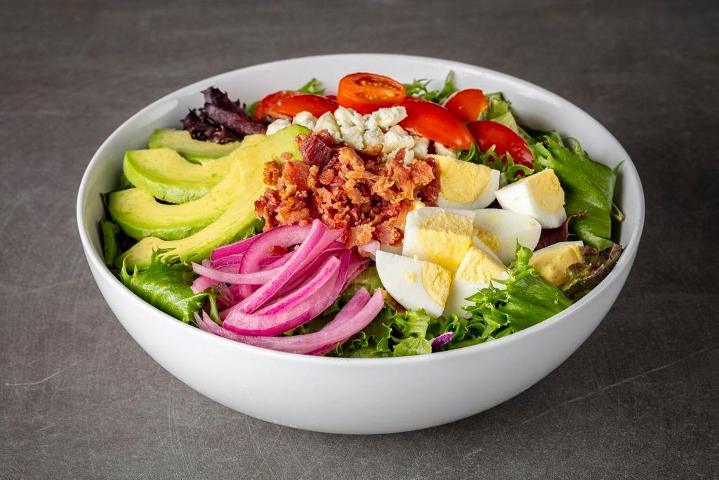 Keto Cobb Salad · Chopped salad mix, mixed greens, avocado, eggs, grape tomatoes, pickled onions, blue cheese crumbles, bacon bits. Served with keto blue cheese dressing