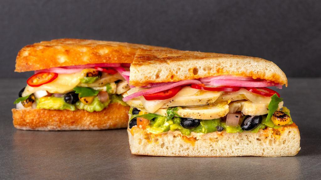 Cilantro Chicken Torta Chicken Sandwich · Roasted cilantro chicken, avocado, corn, black bean salsa, pepper jack cheese, pickled Fresno chili, pickled onions, chipotle aioli with smoky tom atillo salsa on the side. Served with Urbane House Side salad.