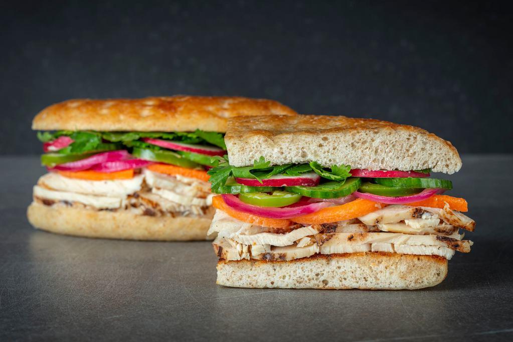 UC Banh Mi Chicken Sandwich · italian chicken, cilantro, cucumber, jalapenos, pickled carrots, pickled onion, red radish, sweet chili aioli. Served with Urbane House Side salad.