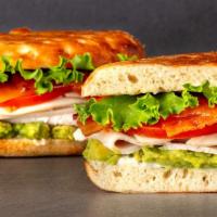 Club Turkey Sandwich · Roasted turkey, applewood smoked bacon, avocado, cheddar cheese, sliced tomato, green leaf l...