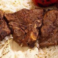 10 Skewers of Lamb Chops · Served with Rice, Pita Bread and Grilled Tomatoes
