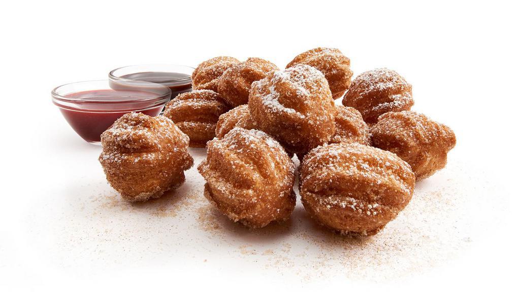 Churro Bites · Churro meets donut. The best of both worlds. Hot and crunchy on the outside and soft and fluffy on the inside, tossed in cinnamon sugar, and served with chocolate and strawberry sour cream dipping sauces with powdered sugar over the top.